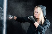 Blond Boxing Woman in Black Punching Bag