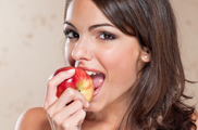 Pretty Young Woman Eating an Apple